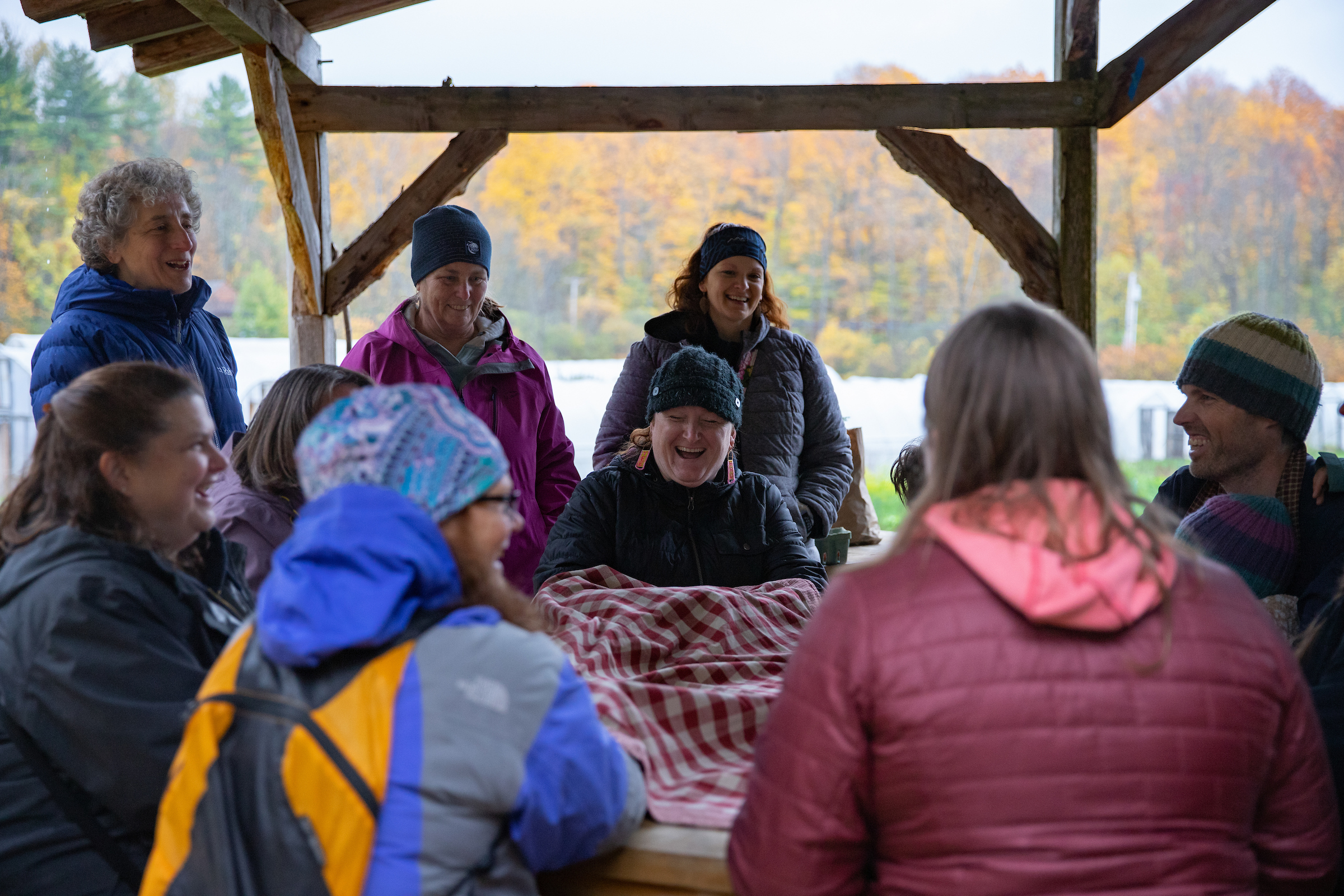 A group sits at a picnic table engaged in an activity