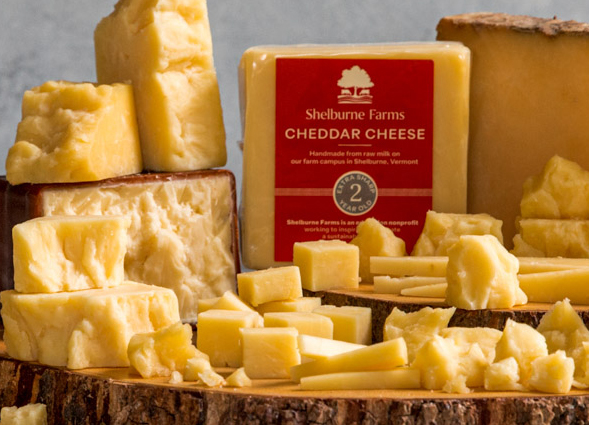 many chunks of cheddar on a block of wood