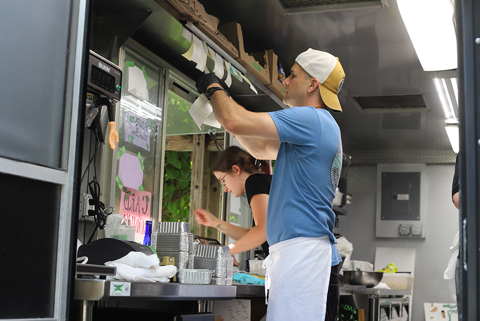 Chef John reviewing order tickets from inside the Farm Cart