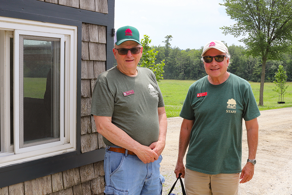 Two men standing outside gatehouse