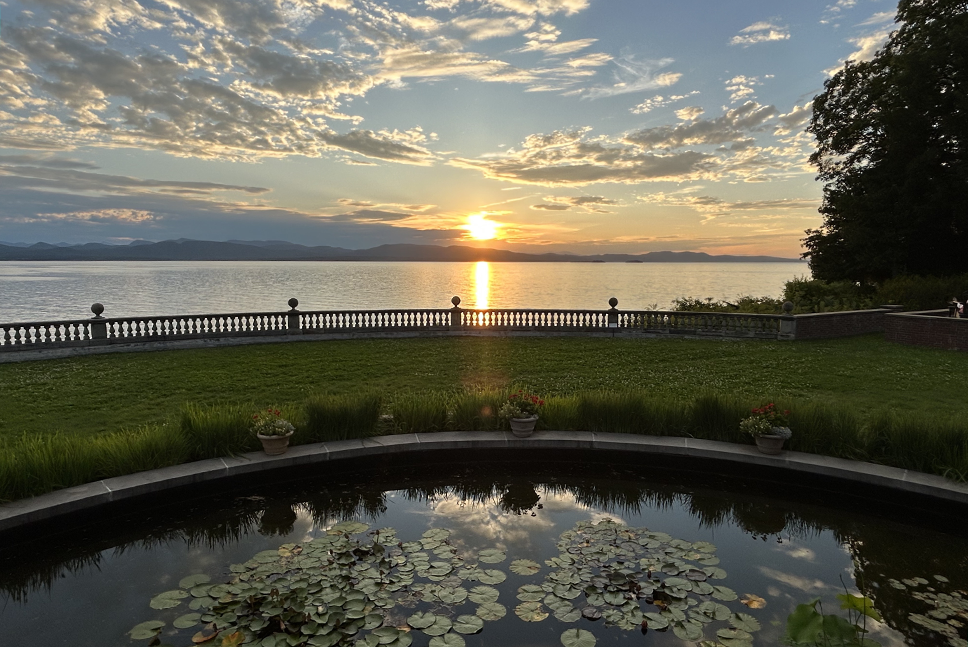 sunset over lake and Inn Flower gardens