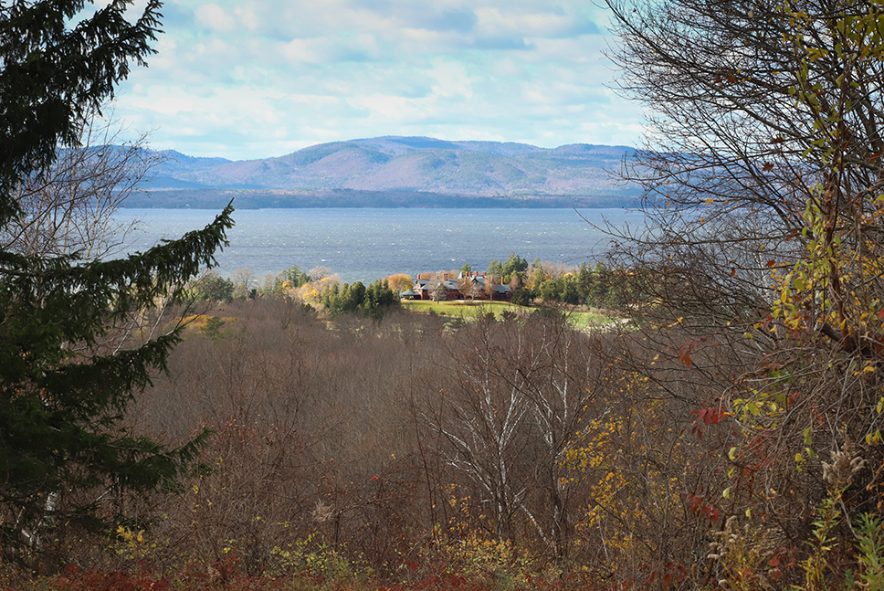 landscape view with inn, lake, and mountains in the distance