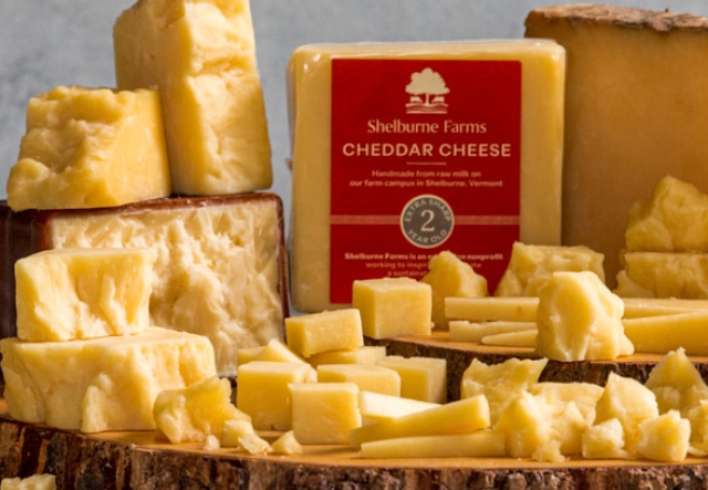 all sorts of cheddar chunks served on a live-edge round of wood