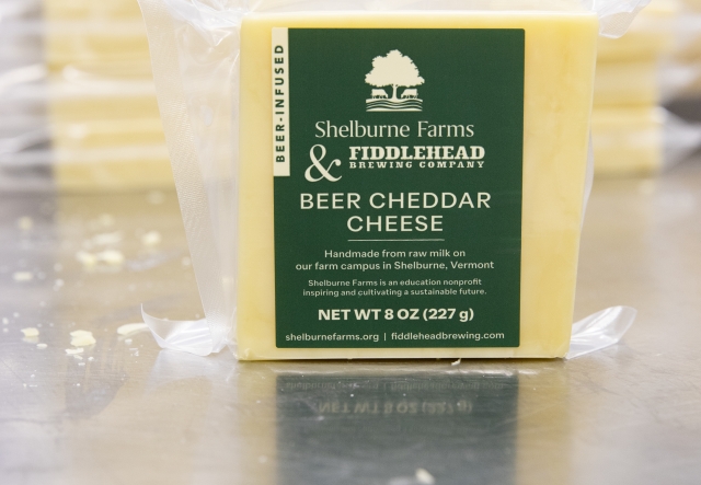 a block of beer cheddar, wrapped in plastic