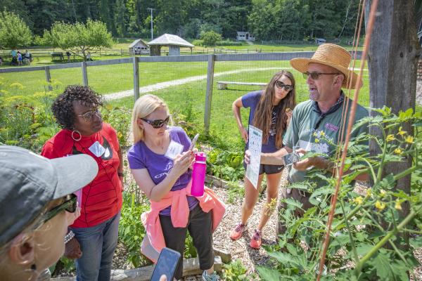 Summer Institute on Education for Sustainability participants meet Farmyard Educator Michael Minchak in the garden. Photo by Bob Schatz.