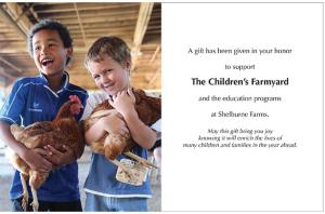 Image of two young boys smiling and holding chickens next to text that reads, "A gift has been given in your honor to support The Children's Farmyard and the education programs at Shelburne Farms. May this gift bring you joy knowing it will enrich the lives of many children and families in the year ahead."