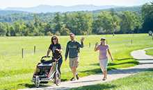 3 people enjoying the trails with a stroller