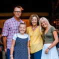 father and mother with two daughters, one a teenager
